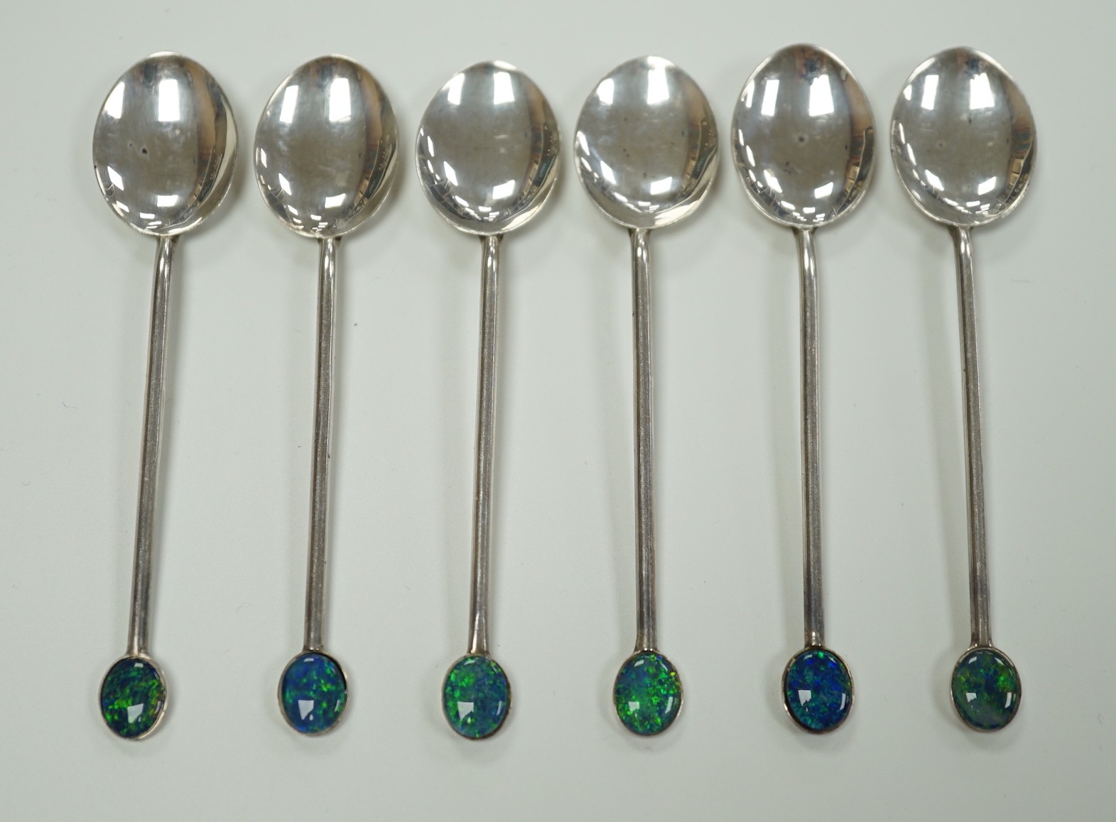 A set of six Australian sterling coffee spoons, with oval black opal doublet set terminals, 92mm.